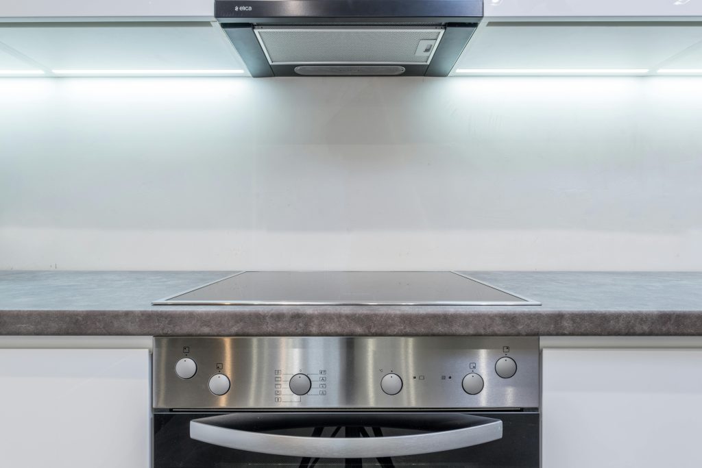 A sleek, modern kitchen with steel appliances and minimalist design.