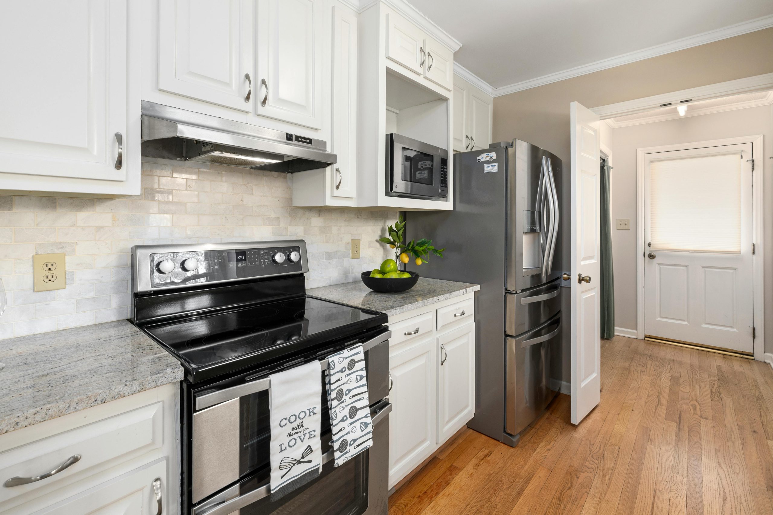 Contemporary kitchen featuring stainless steel appliances and granite countertops.